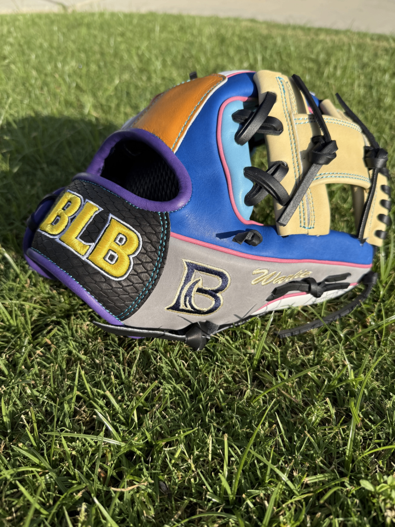 Finished BLB custom glove in blue, tan, grey and orange with pink accents and yellow BLB embroidery