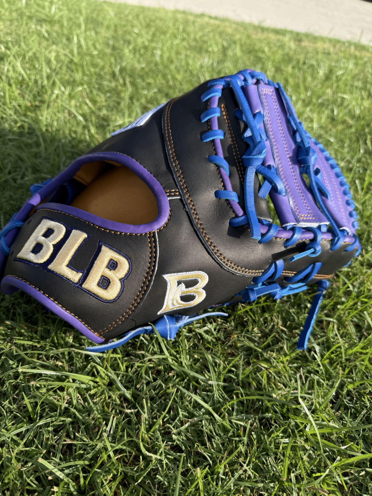 Finished BLB custom glove in black with purple trim, blue laces and gold BLB embroidery