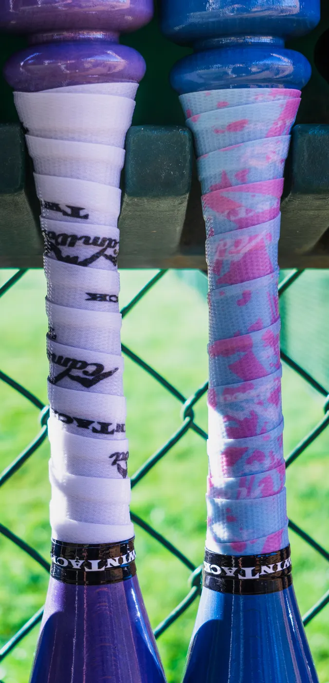 Close-up of two wrapped CamWood training bat handles
