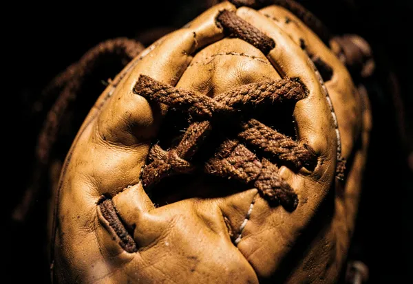 Close detail of leather glove webbing and rawhide lacing